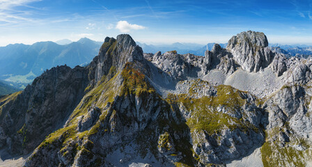 Fototapeta premium Scenic view of mountain peak Hochturm in Hochschwab region, Styria, Austria. Steep rocky cliffs covered in deciduous trees in vibrant autumn colors. Wanderlust Austrian Alps.