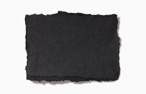 Torn black paper on white background