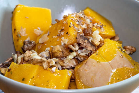 Oven-roasted pumpkin drizzled with olive oil and sprinkled with chopped walnuts.
