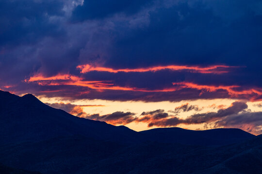 Dramatic sunset sky above hills