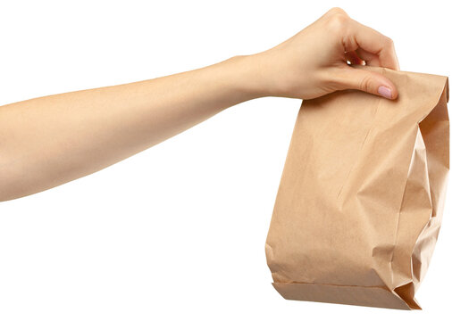 Hand holding a brown paper bag showing delivery or takeaway activity