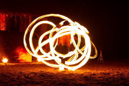 Fire show of man swing fire and dancing on the beach at Koh Kood, Trat, Thailand.
