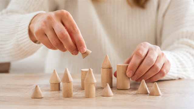 Adult patient practicing fine motor skills and hand coordination with wooden blocks during brain rehabilitation therapy. Close up of stroke or injury recovery process