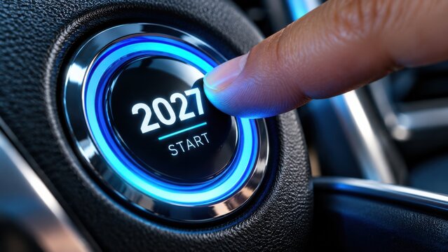 A hand pressing bright blue glowing 2027 start button in a car for future activation.