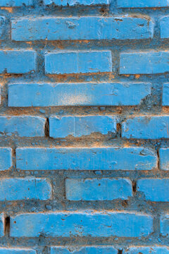Blue painted brick wall with weathered texture
