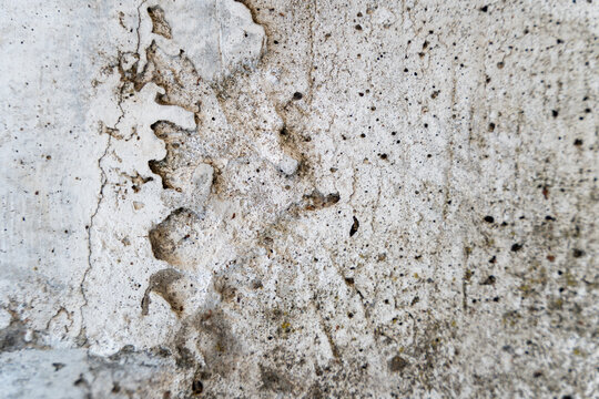 Weathered rough concrete texture background with cracks and blemishes