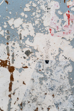 Peeling paint texture on a weathered multicolored wall surface