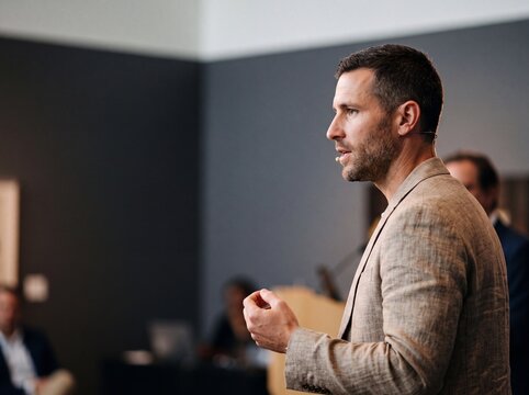 Confident Male Keynote Speaker Giving a Business Presentation or Speech at a Corporate Conference