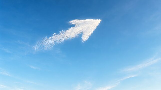 Arrow shaped cloud in clear blue sky representing direction growth success and future strategy path.