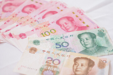 China currency , Many yuan bank notes Placed on the table. The yuan is the currency of china that is used to change, buy, sell, accumulate, and invest in china stock. © Shisu_ka