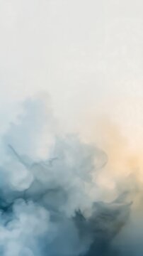 Abstract soft blue and beige smoke clouds flowing in a dreamy ethereal composition with a gentle gradient light
