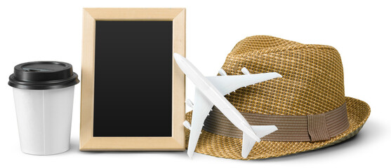 Travel essentials on a table with coffee cup, hat, model airplane, and empty picture frame © fotofabrika