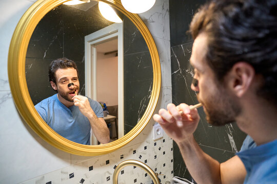 Man brushing teeth during morning grooming routine