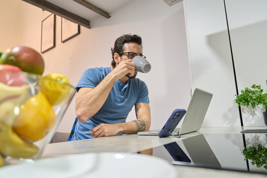 Man drinking coffee working from home lifestyle