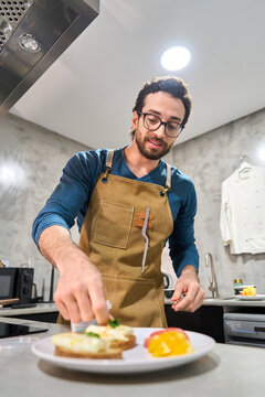 Man preparing healthy homemade meal in kitchen