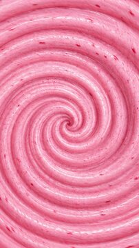 Abstract swirling pattern of soft pink yogurt or ice cream, macro food photography Top view of creamy strawberry swirl texture background with tiny fruit bits portrait background