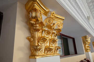 Gilded Corinthian column capital in classical theater interior © Светлана Лазаренко