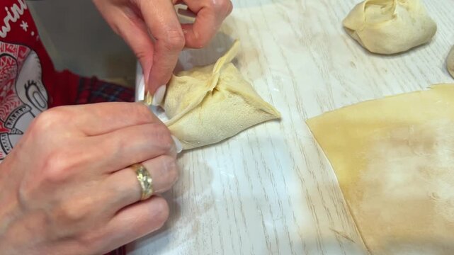Close-up of woman hands making festive manti dumplings for Eid
