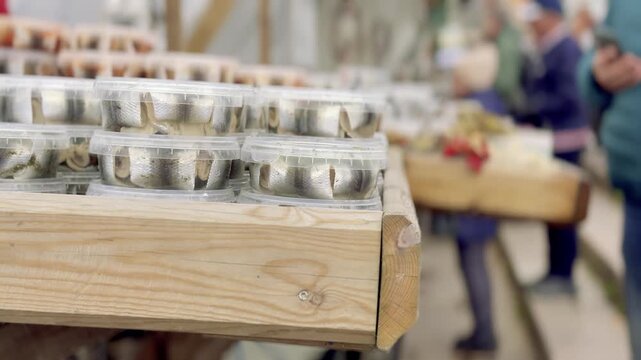 Rows of Pickled Herring Jars on a Market Stall Table
