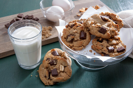 Chocolate chunk peanut butter cookies with milk and baking ingredients