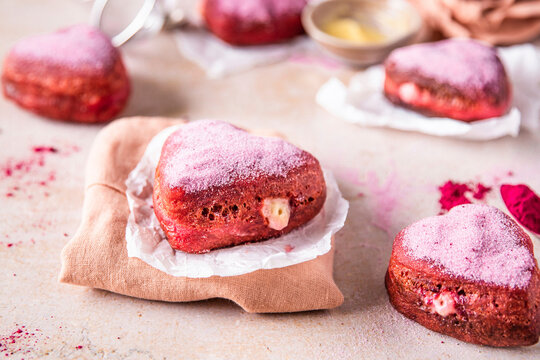 Heart-shaped Pink sugar-coated donuts with cream filling