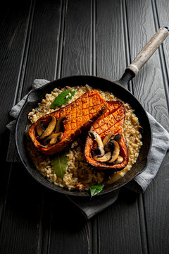 Roasted butternut squash with mushroom risotto in cast iron skillet