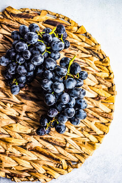 Red ripe grapes grape bunch on woven placemat