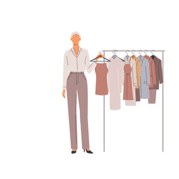 Fashionable woman presenting a collection of elegant apparel on a clothing rack, highlighting stylish garments for a modern wardrobe or boutique display