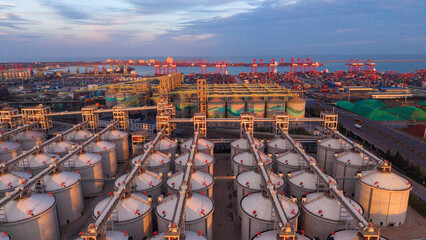 Coastal Grain Reserve Base Under Morning Light, Backed by Seaport and City © Zhaorui