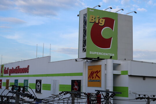 SAMUT PRAKAN, THAILAND - OCTOBER 12, 2026: Big C Supercenter shopping mall with its large red and green logo sign, seen from the BTS Skytrain Pu Chao station
