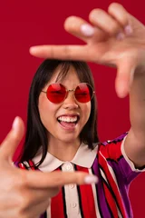 Beautiful asian woman portrait, asian woman framing face with hands smiling © oneinchpunch