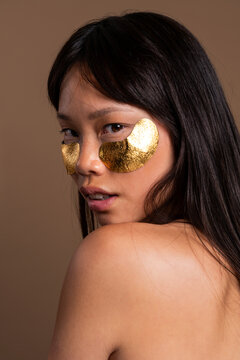 Beautiful asian woman portrait, asian woman having a luxurious gold under eye patch treatment