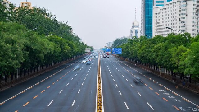 Long avenue framed by green trees and apartment blocks in Beijing