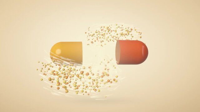 Orange and yellow capsule pill splitting open and releasing swirling granules on a beige background