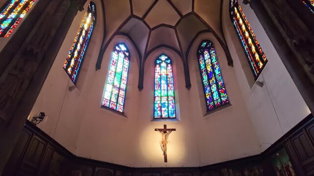 Stained glass and crucifix in Saint Pierre le Vieux church Strasbourg tilt up