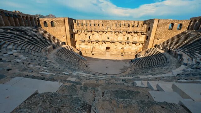 Aspendos Ancient City amphitheater in Antalya, Turkiye, showcases timeless Roman heritage beneath a vibrant blue sky.