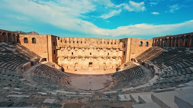 Aspendos Ancient City amphitheater in Antalya, Turkiye, showcases timeless Roman heritage beneath a vibrant blue sky.