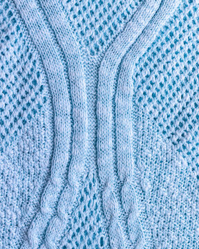 Light blue knitted sweater texture, close up of cotton fabric with cable knit and openwork pattern