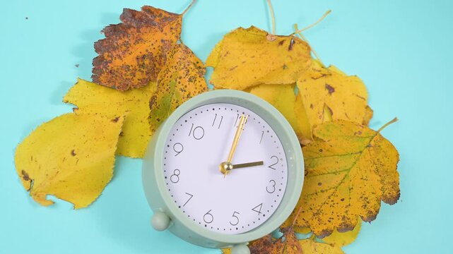 End of daylight saving time in autumn, winter time changeover, alarm clock fall back switch, colorful foliage