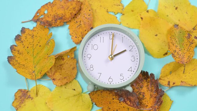 End of daylight saving time in autumn, winter time changeover, alarm clock fall back switch, colorful foliage