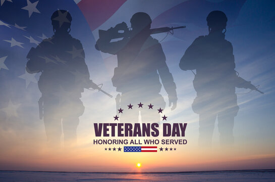 Silhouettes of a soldiers with USA flag against the sunset. Veterans Day concept