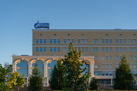 Gazprom office facade with arched windows and greenery in Ukhta, Komi Republic