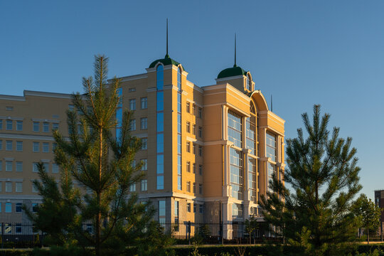 Gazprom Transgaz Ukhta office architecture framed by conifers at sunset