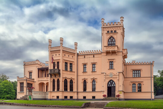 General view of New Castle in Aluksne, Latvia. Daytime shot showcasing tudor gothic revival architecture