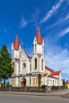 General view of Church of All Saints in Svencionys, Lithuania. Daytime view showcasing historicist architecture with a red roof.