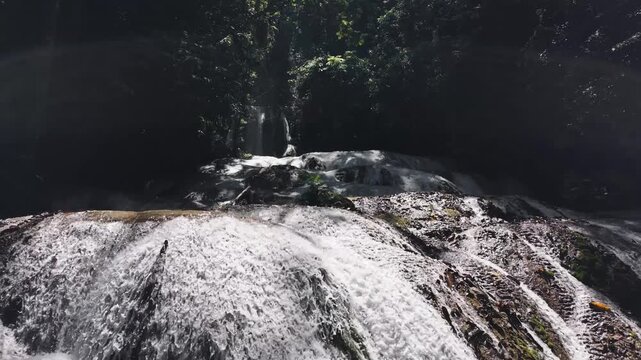 Cascading waterfall flowing over rocks in sulawesi jungle