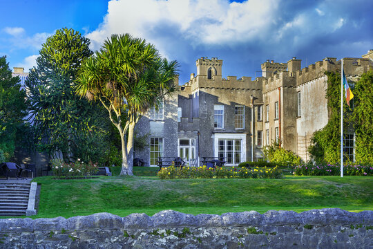 View of Ardgillan Castle with a garden and palm tree in County Dublin, Ireland. Daytime shot of historic architecture