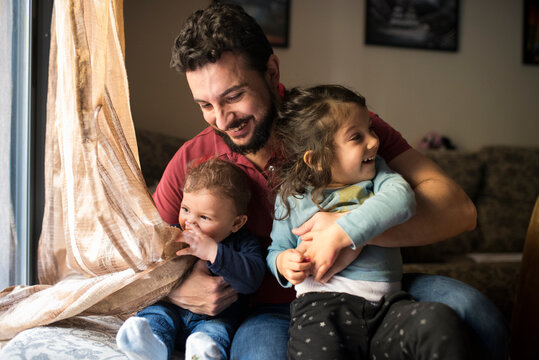 Father and his children at sofa home
