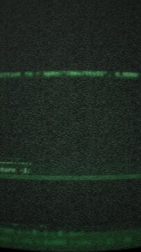 Green source code scrolling on a retro CRT phosphor computer terminal screen.