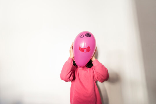 Baby with balloon in his face